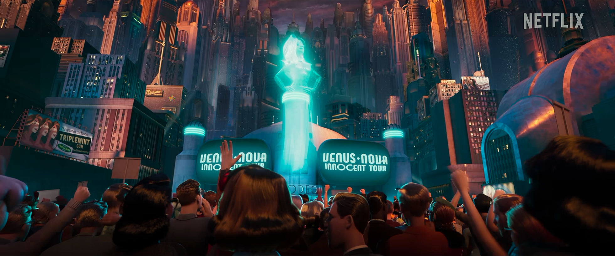 A futuristic cityscape at night with tall skyscrapers, vibrant lights, and a massive crowd gathered in front of a holographic fountain displaying the words 'Venus Nova Innocent Tour.' A large hologram of a woman is projected above the fountain. The s