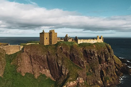 The dramatic ruins of Dunnottar Castle, an impregnable medieval fortress perched on a rocky headland overlooking the North Sea.