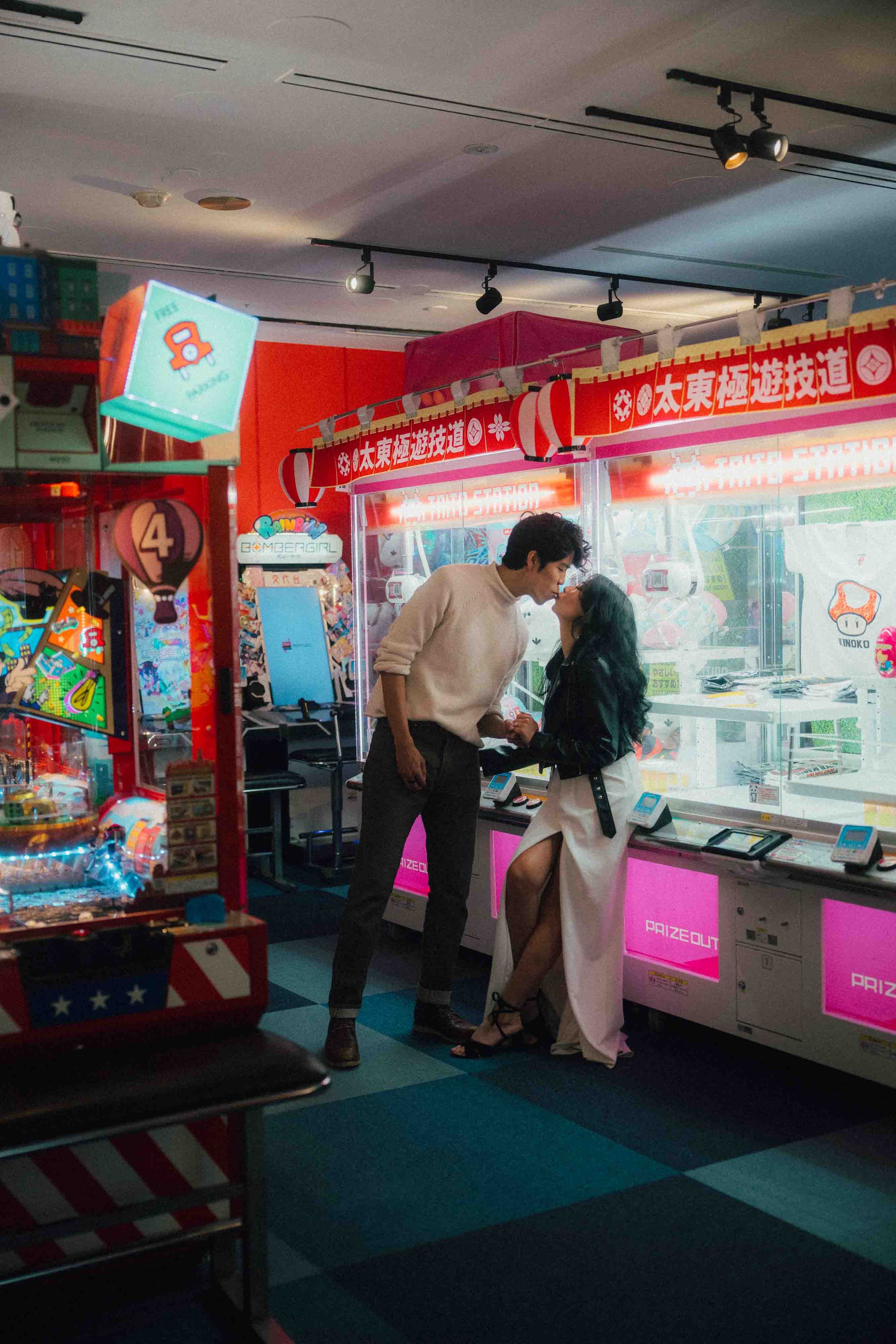 Couple kissing in game arcade.jpg