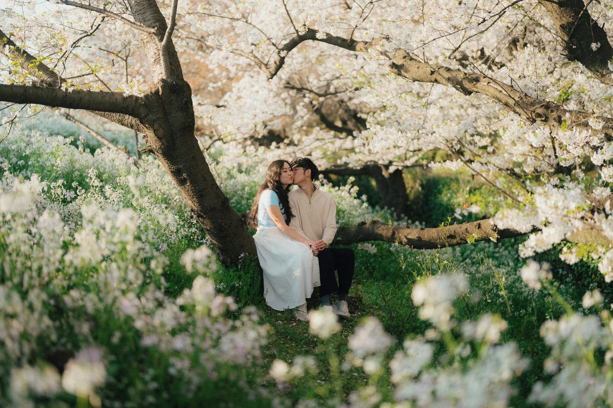 Couple kissing surrounded by flowers.jpg