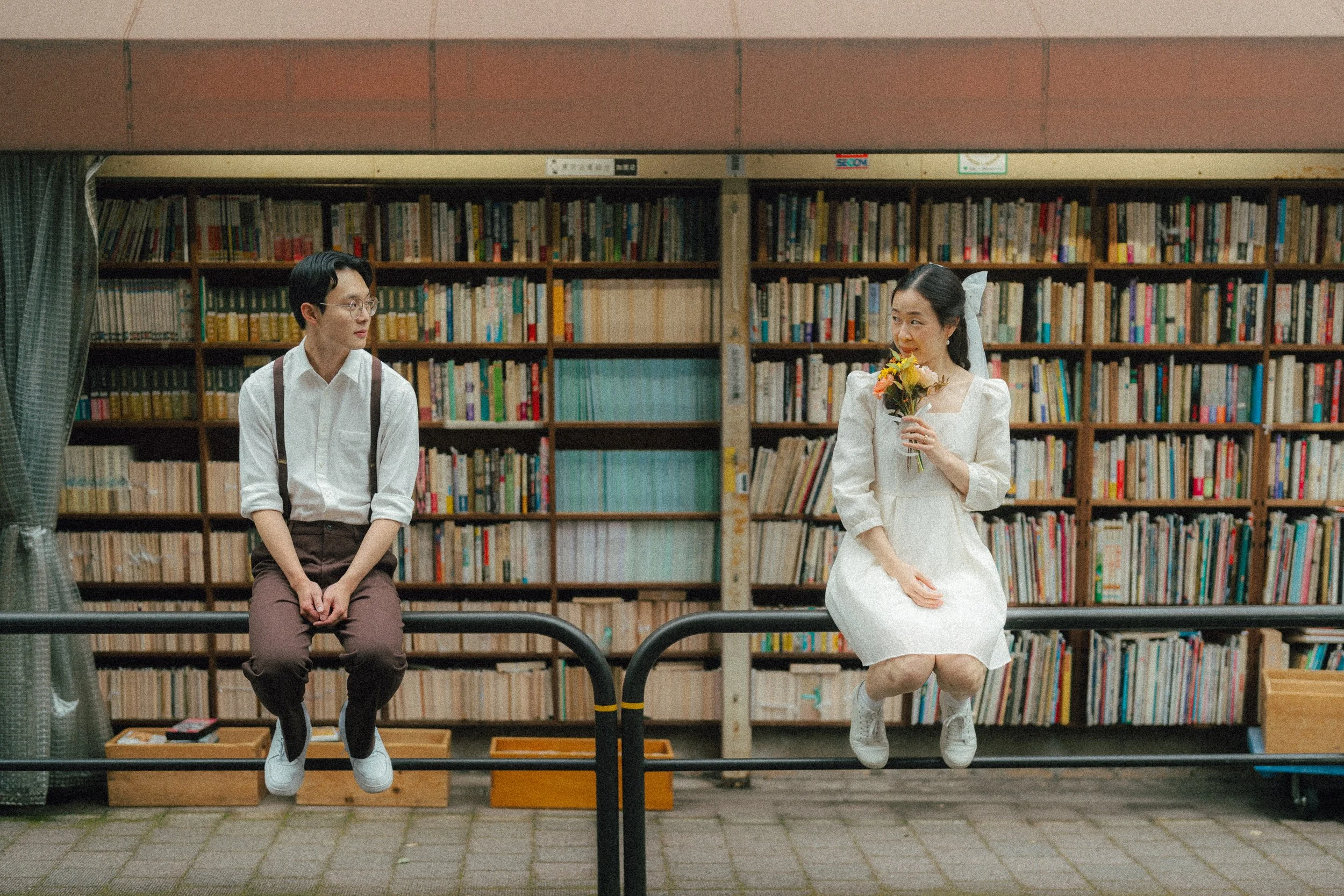 Tokyo Couple Photography - Sitting on the Rails in Book town Jimbocho