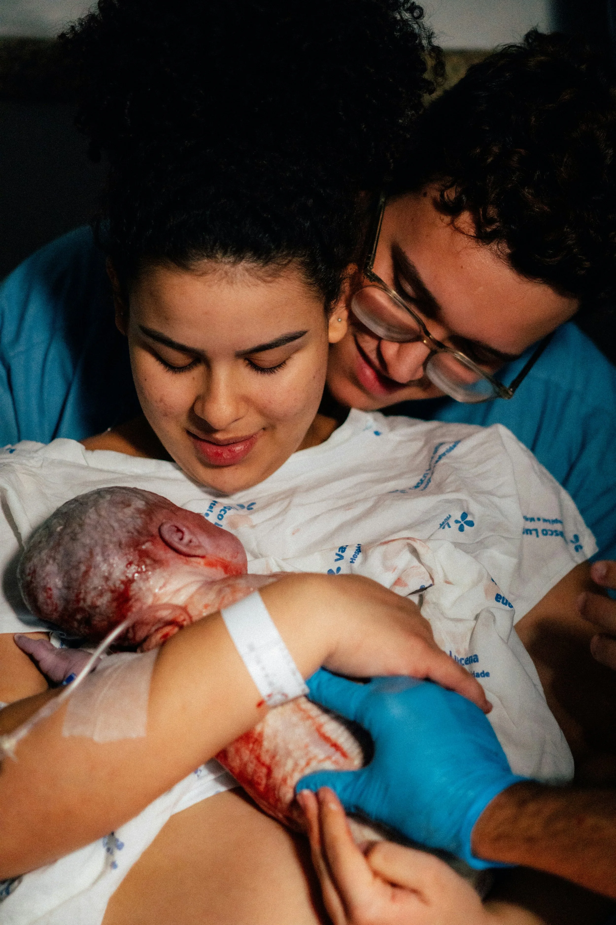 New parents cradling a newborn baby