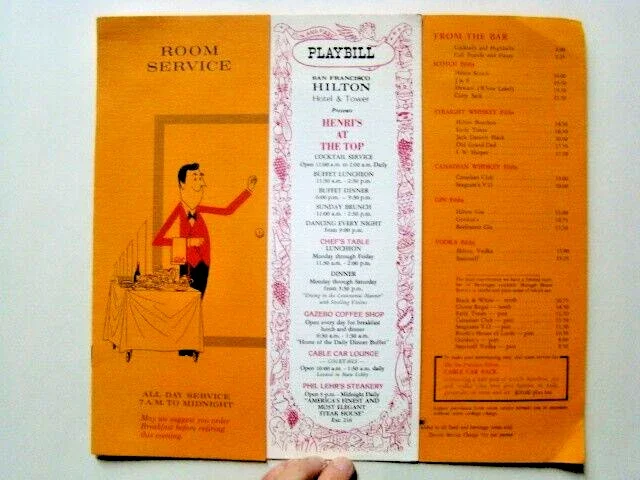 A vintage-looking Hilton Hotel room service menu. The middle flap is white and framed with an ornate illustration, while the left and right are printed on orange paper. The front flap has a cartoon illustration of a room service worker with food.