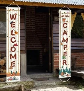 A stock image of summer camp banners being hung on both sides of a cabin doorway. They collectively read "Welcome Camper."