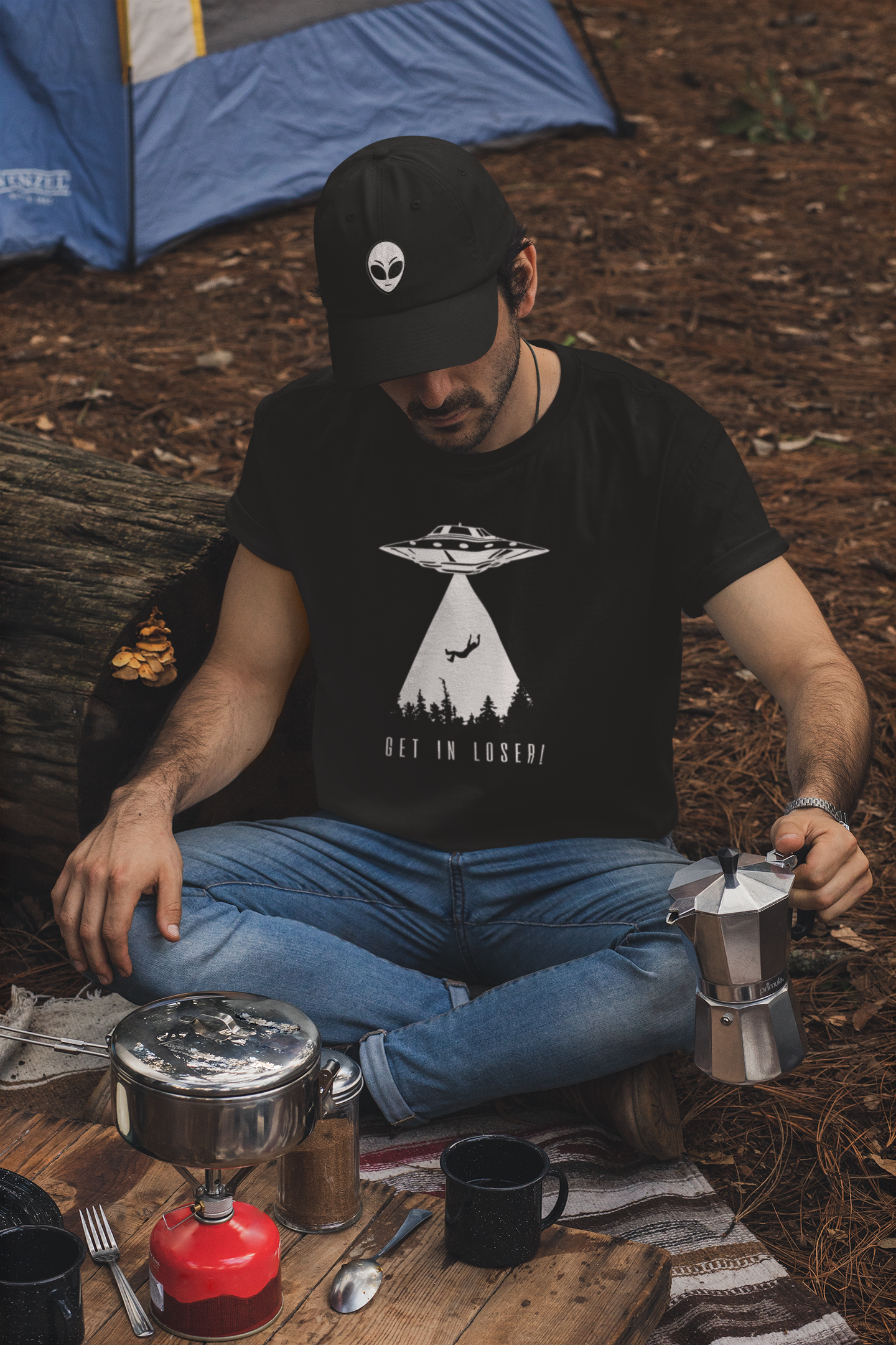 t-shirt-and-dad-hat-mockup-of-a-man-making-coffee-in-a-camping-site-30476.png