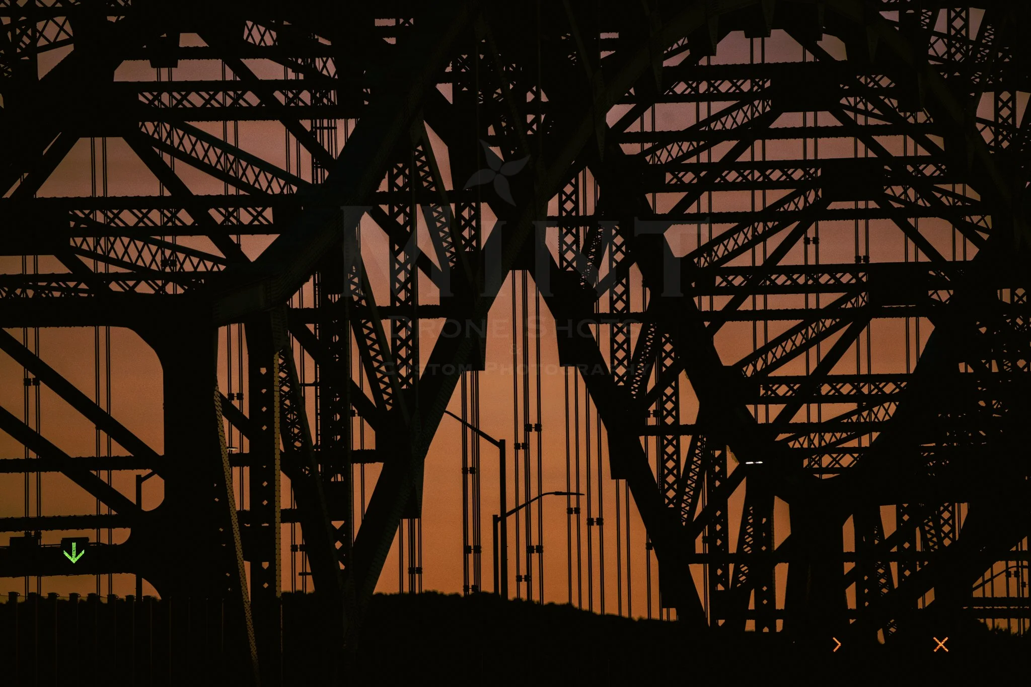 Silhouette of a bridge against a sunset sky.