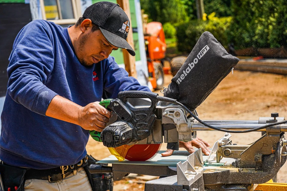 Carpenter using a miter saw outdoors