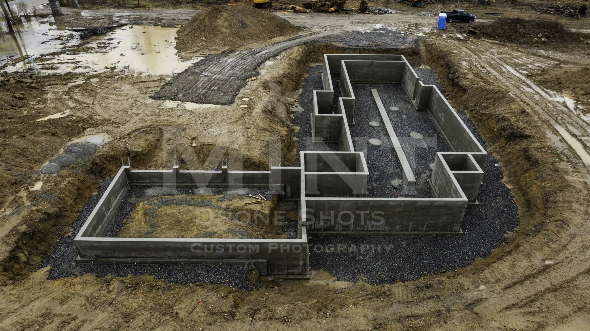 Construction site with concrete foundations and gravel base