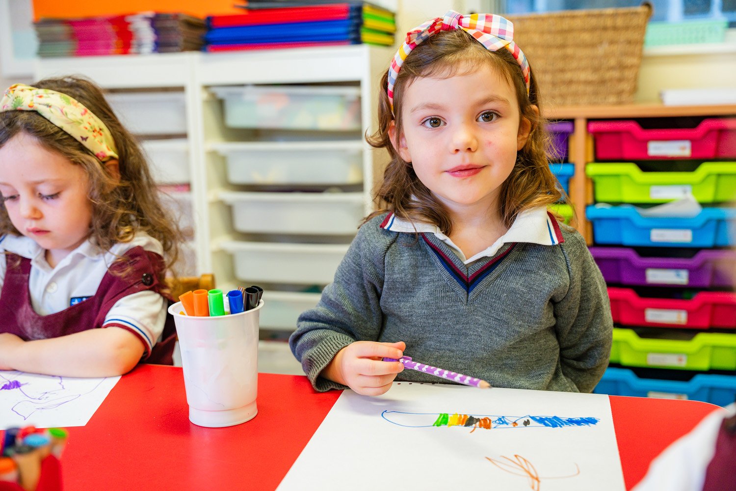 DSC03368-girl-drawing-with-pencil-at-red-table.jpg