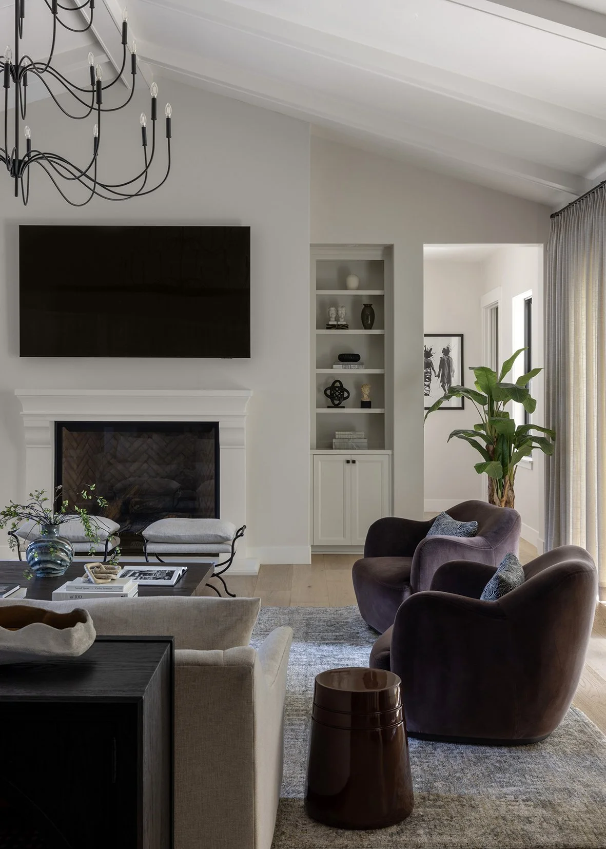 This oversized coffee table anchors the living room with rich wood tones, classic trestle detailing, and timeless craftsmanship. Designed for both function and style, its generous scale creates a natural gathering point while showcasing layered styli