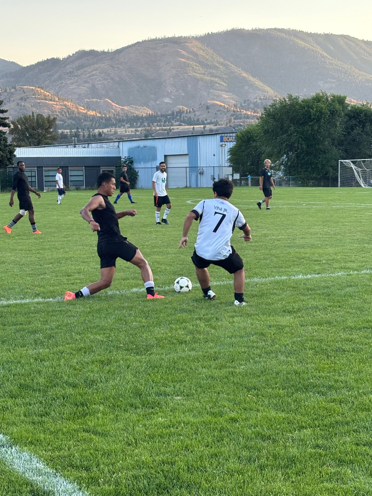 Players battle for the ball with Penticton (White) against Osoyoos (Black) colliding in the South Okanagan Men's Soccer League