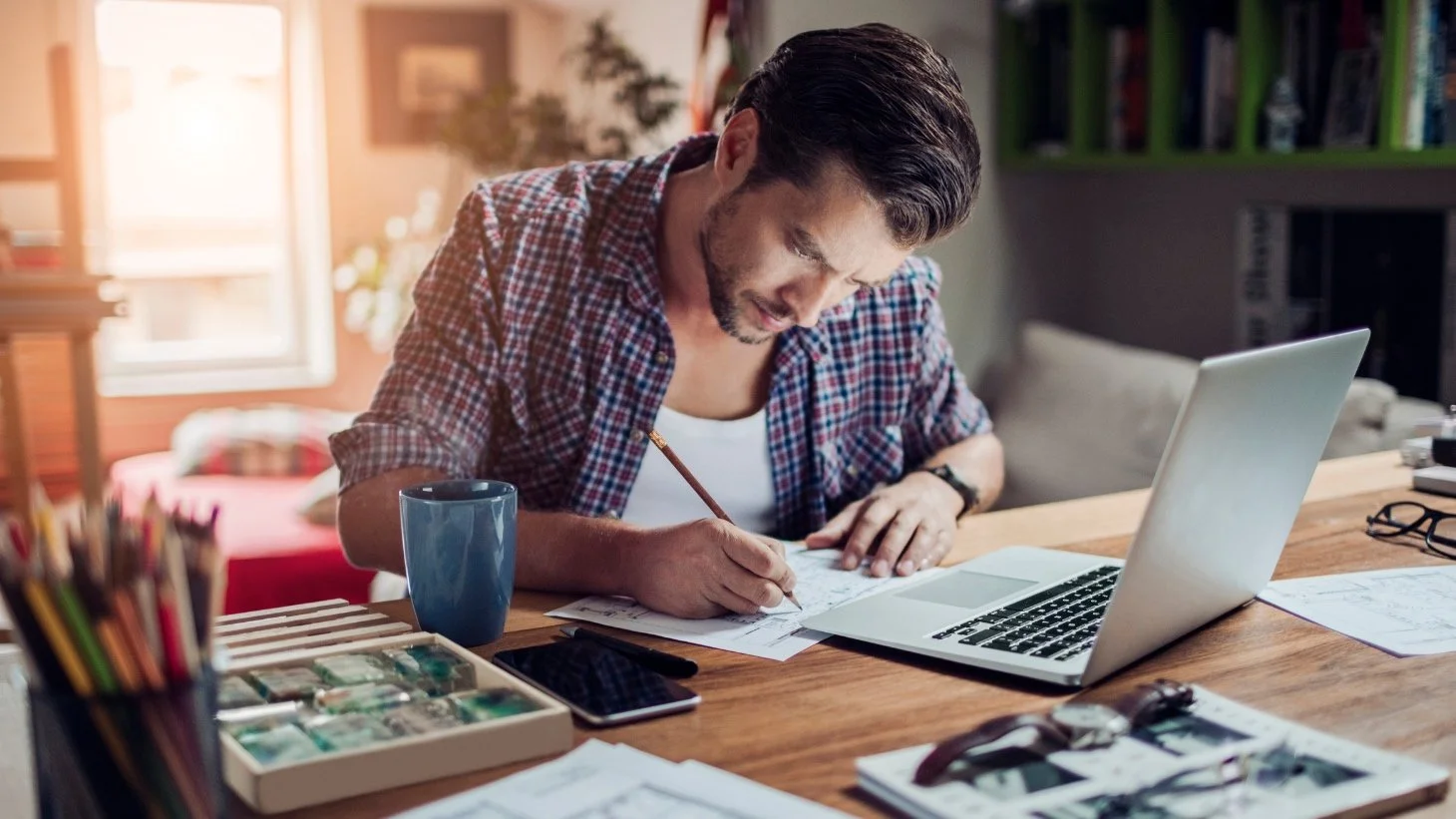 Man focused on art making and meeting for virtual online art therapy with Fresh Therapy LLC.