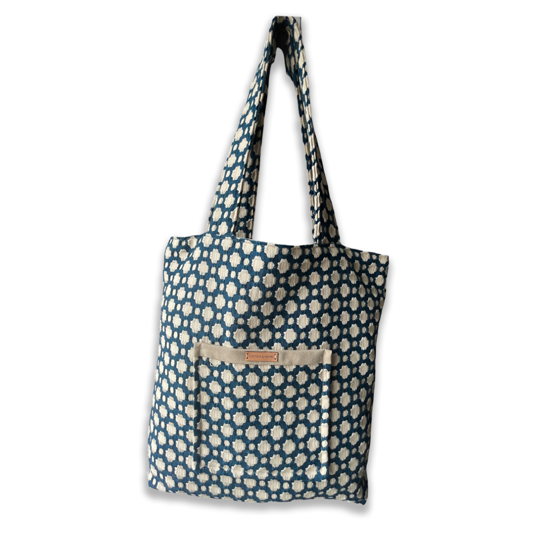 Blue and white patterned tote bag with front pocket