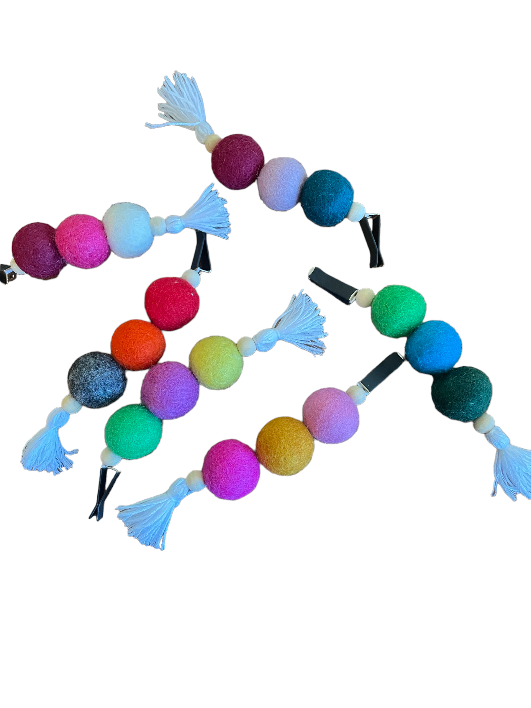 Colorful felt ball garlands with tassels on a white background.