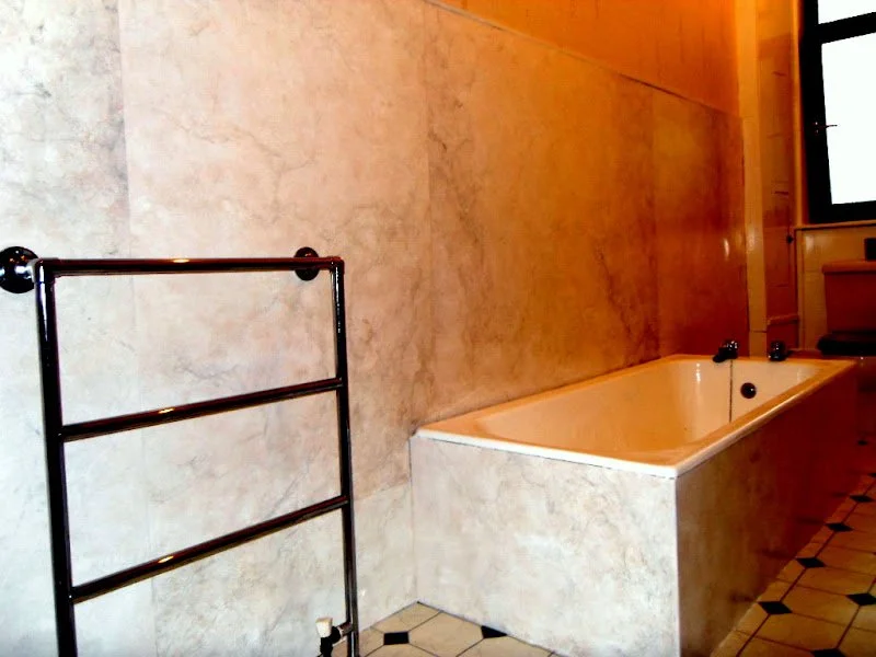 Marbled bath and wall panelling.