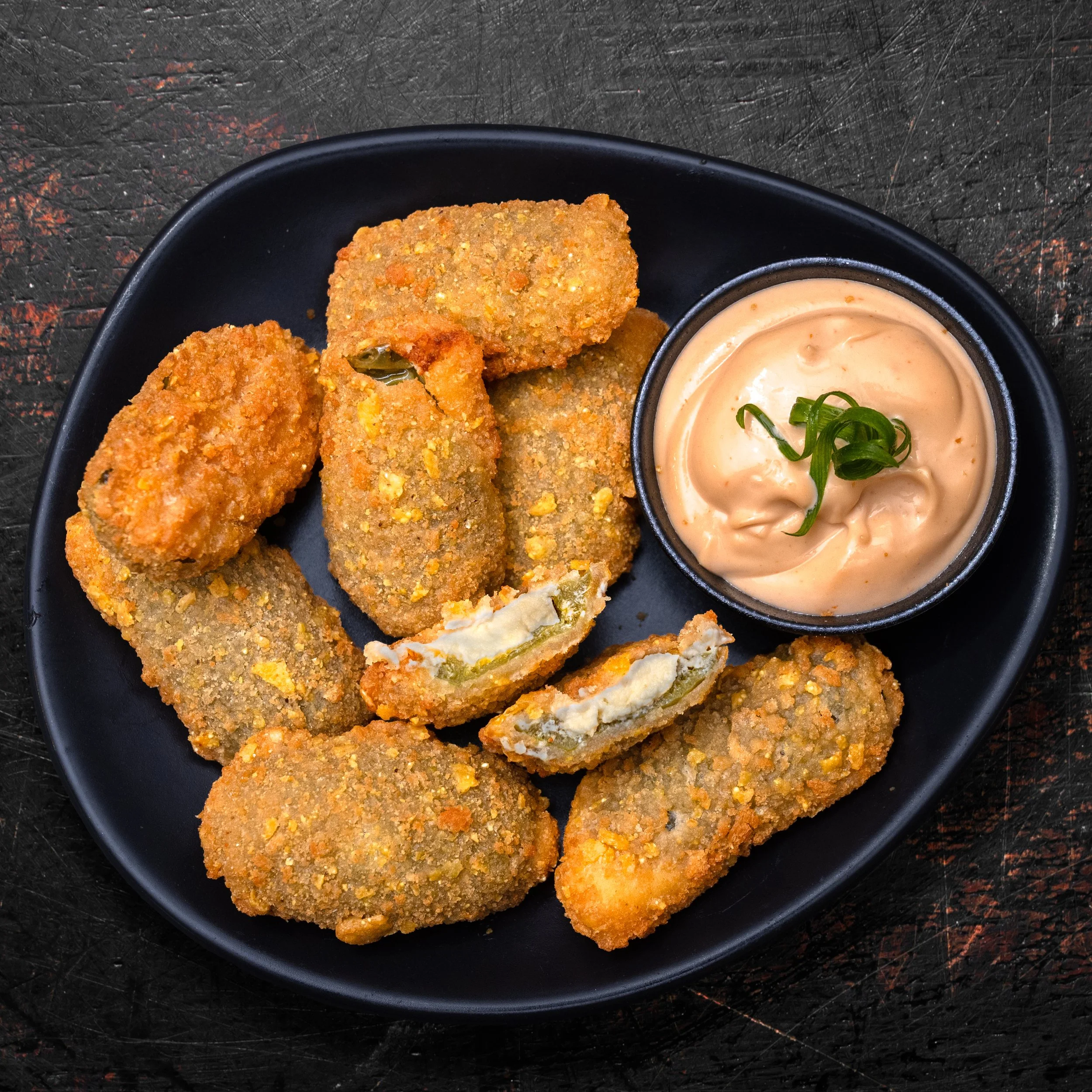  
 JALAPENO POPPERS 
 8 deep fried crumbed jalapenos filled w/ cream cheese, served w/ secret house sauce.