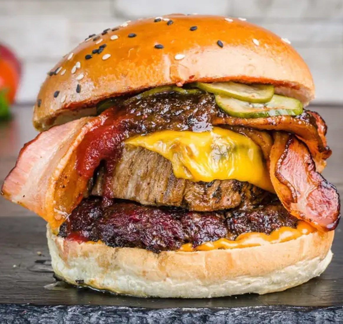  
 FRISKY BRISKY 
 
Smoked brisket, Smoked beef patty, Steaky Bacon American cheese, Cherry Cola BBQ sauce, Chipotle aioli, Bacon Jam, Pickles.