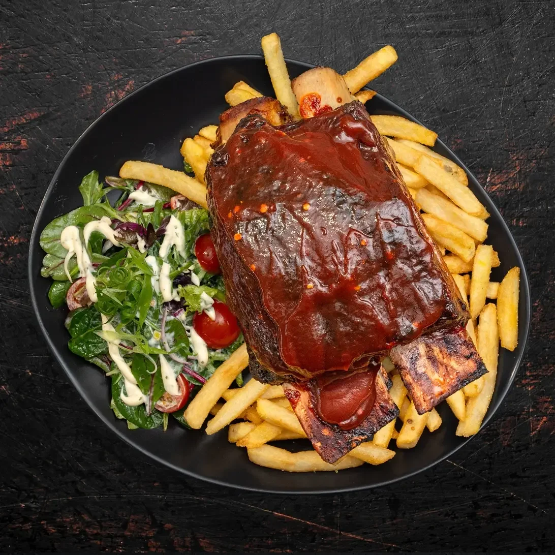  
 BBQ BEEF SHORT RIBS 
 
Beef Short Ribs, Grass-Fed Marbling, Low and Slow Cooked to Fall off the Bone,  Coated with your choice of house-made Smokey BBQ or Rib Sauce, Served with seasoned fries and ranch salad.