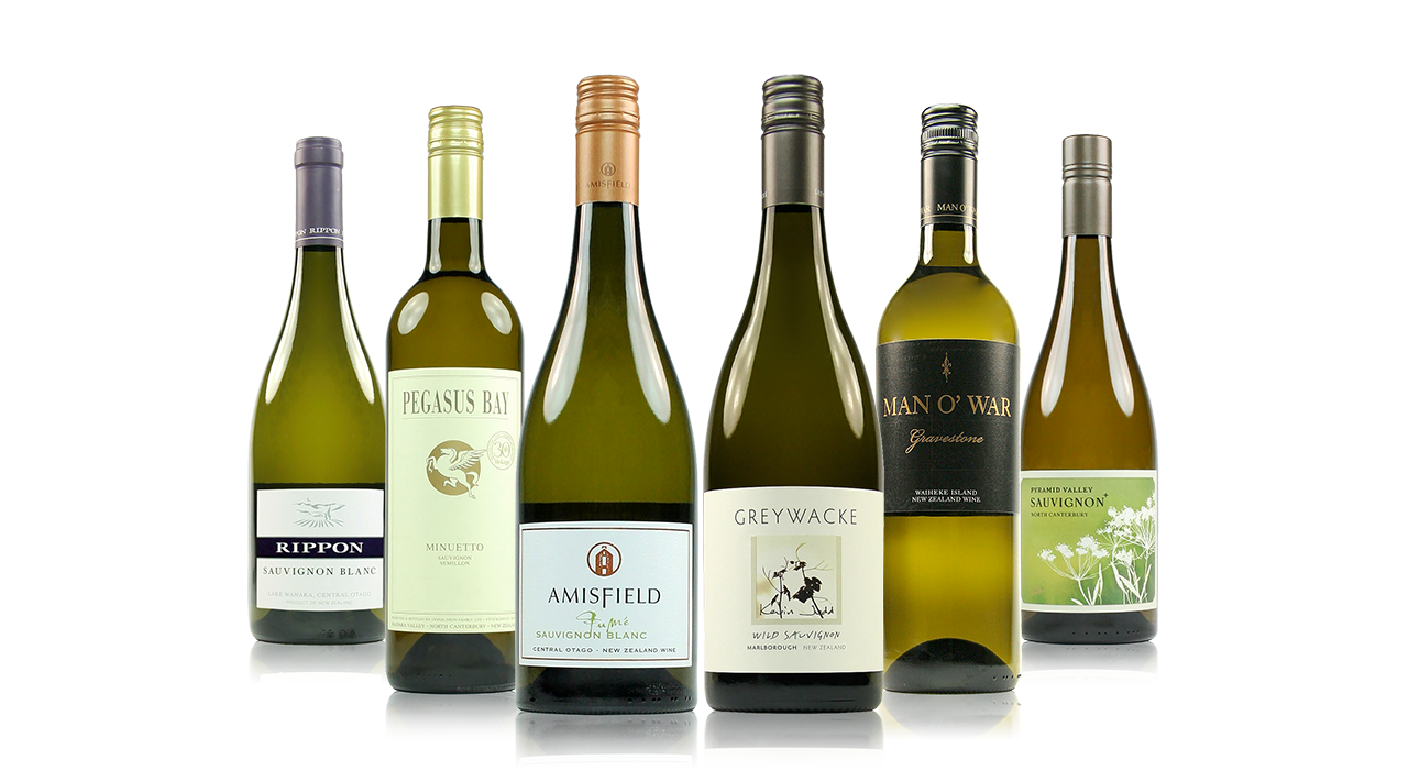Six bottles of white wine with different labels displayed on a reflective surface.