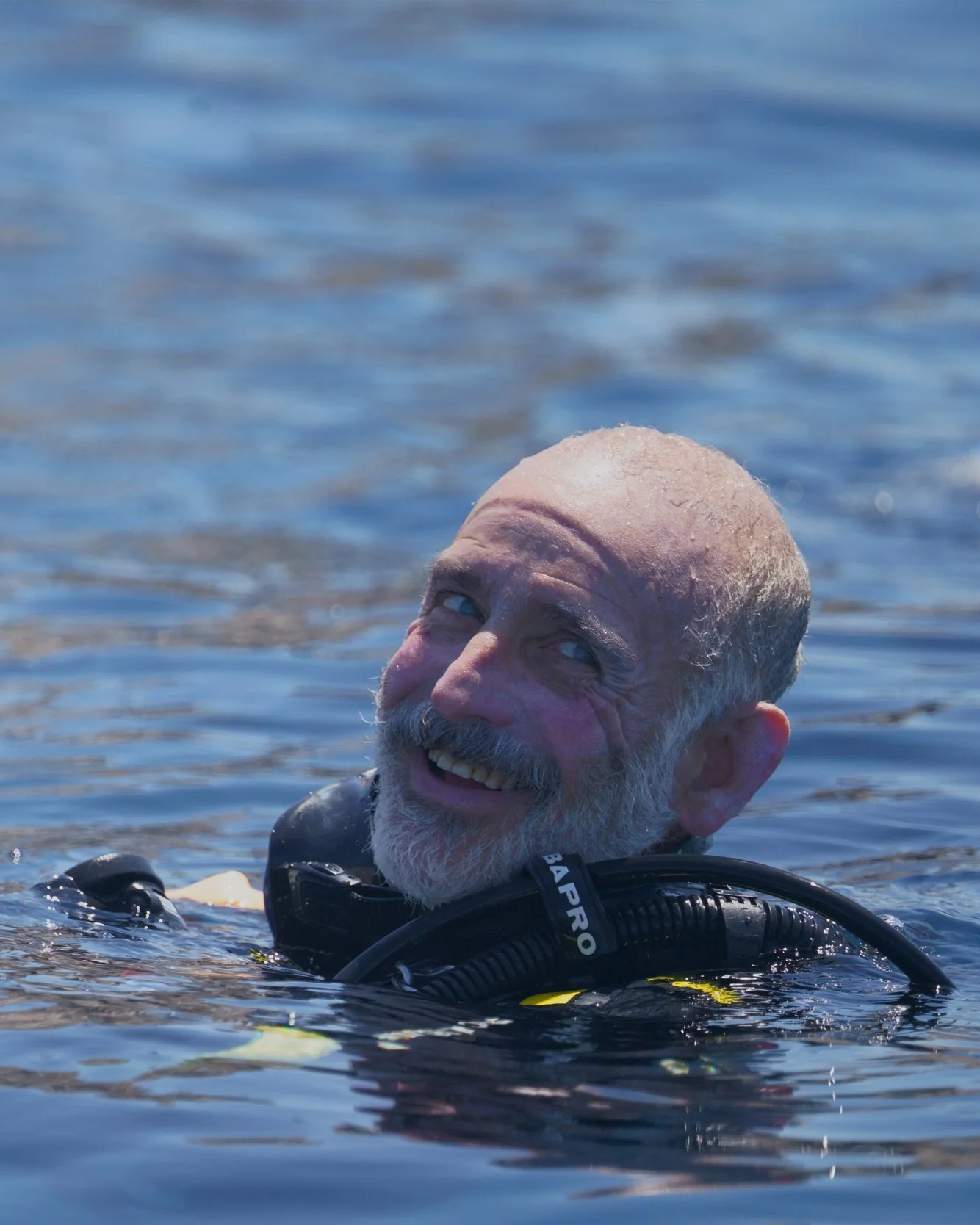 Terry Feinberg swimming on the surface in SCUBA gear