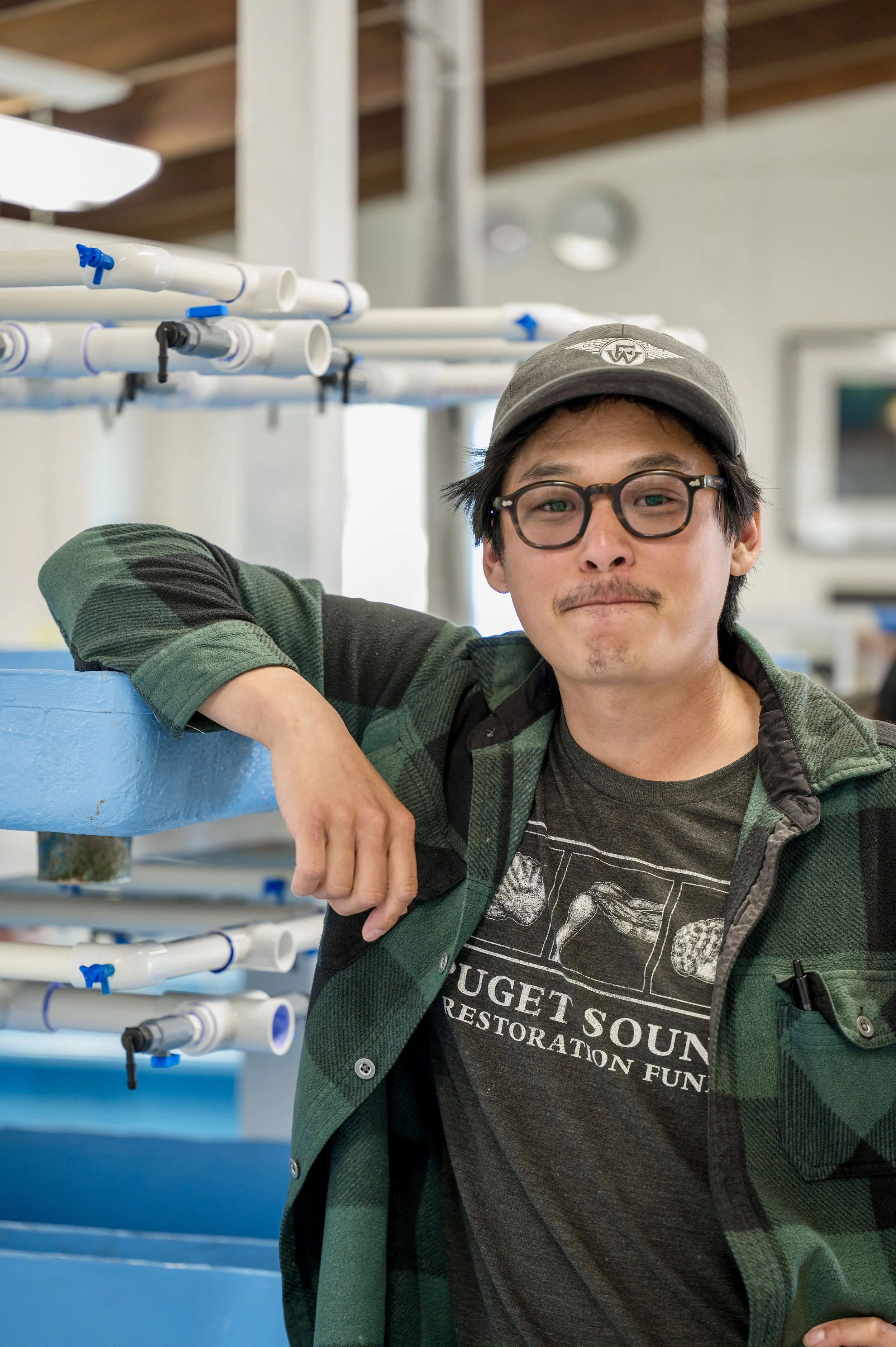 Andrew Kim looks at a slide with microscopic algae