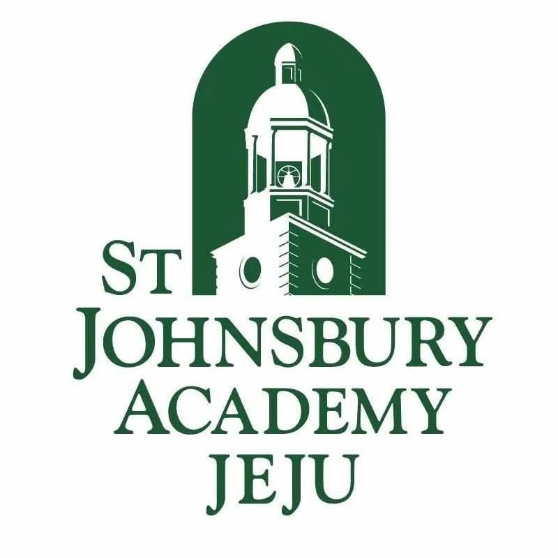 Logo for St. Johnsbury Academy in Jeju, featuring a stylized clock tower or monument with surrounding text.