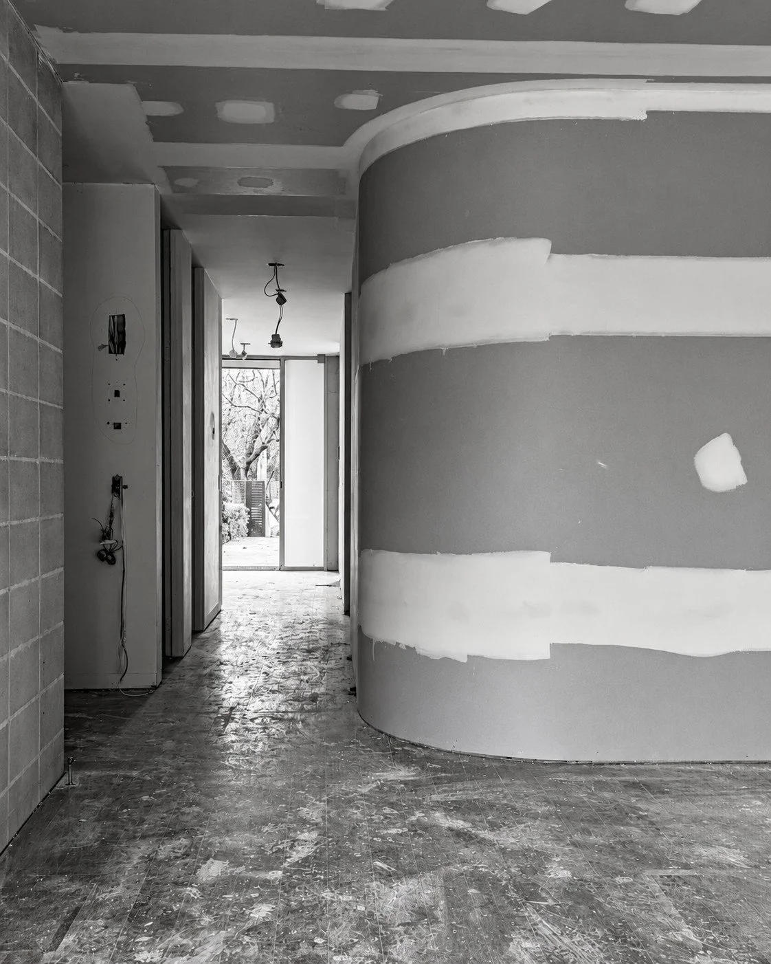 The curved wall leading towards the kitchen during construction of Lorde House.