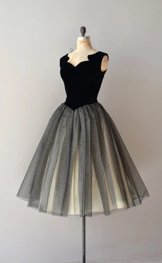 Black fitted bodice and full grey skirt displayed on a dress form.