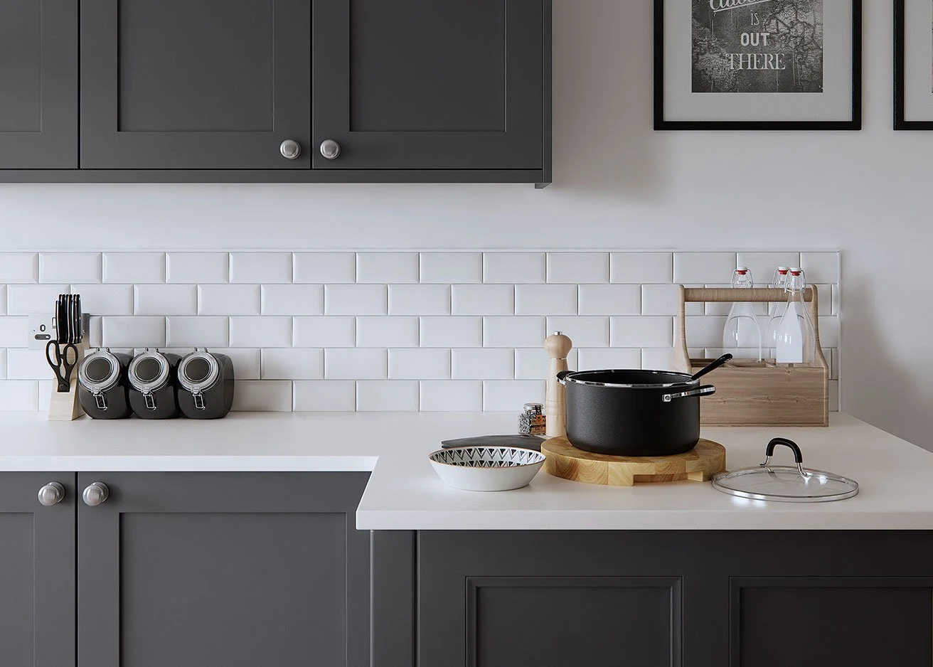 Dark cabinetry above a white subway-tiled splashback and pale benchtop.