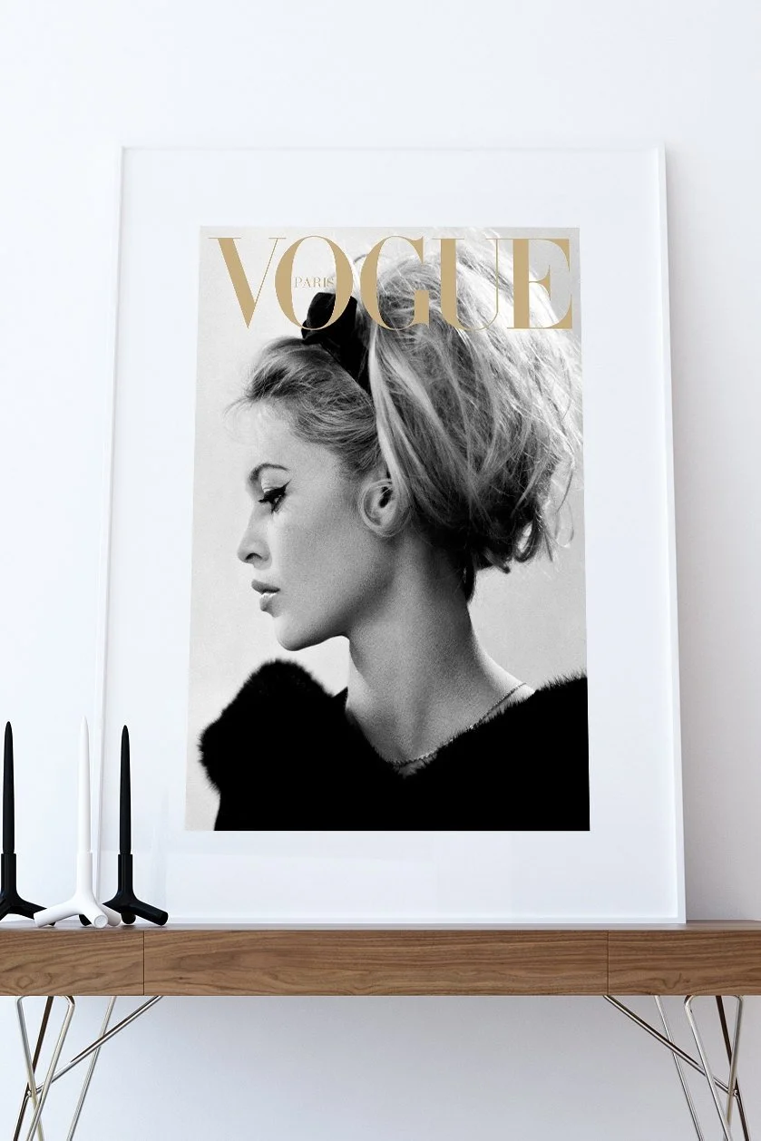 Framed Vogue cover photograph displayed on a timber console.
