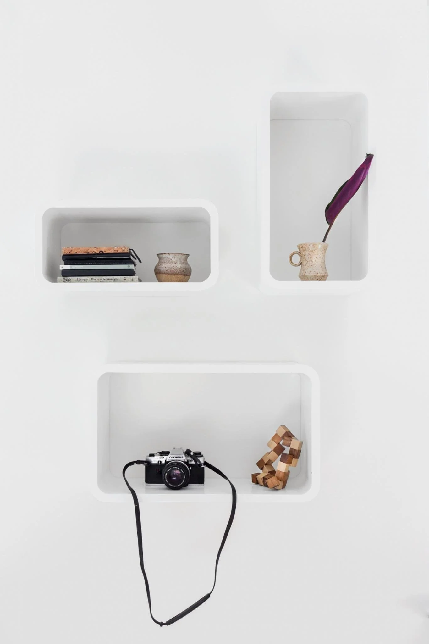 Small recessed wall niches displaying everyday objects.