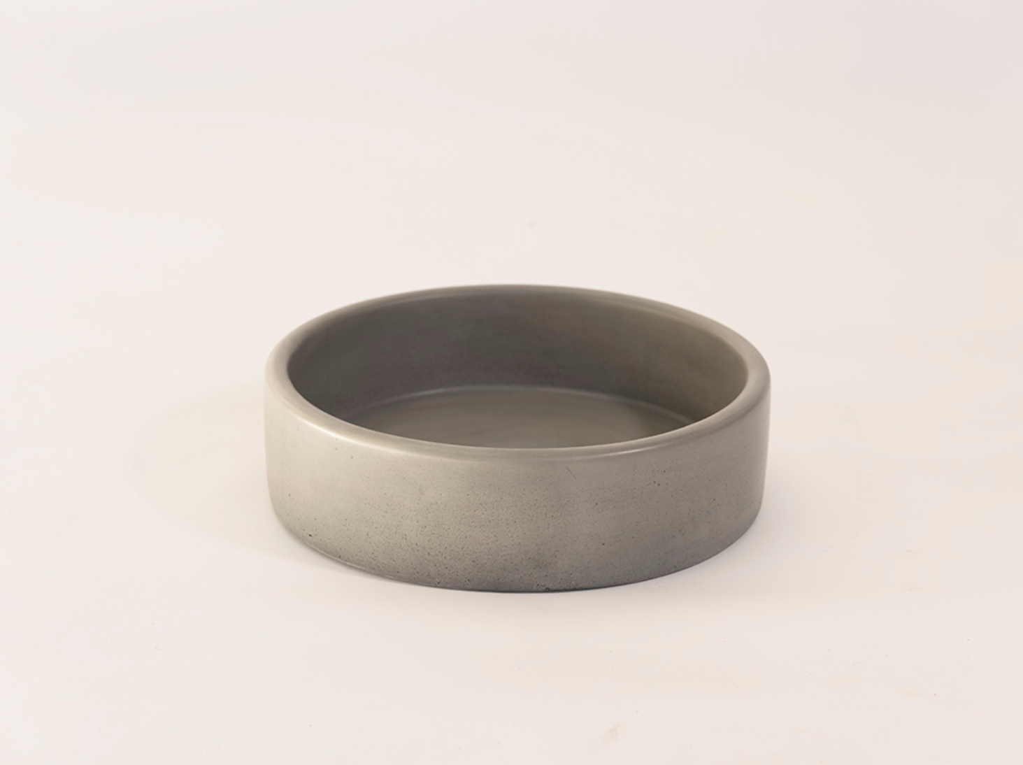 Round grey vessel basin displayed against a pale background.