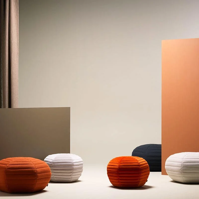 Rounded ceramic vessels in warm rust and cream tones.