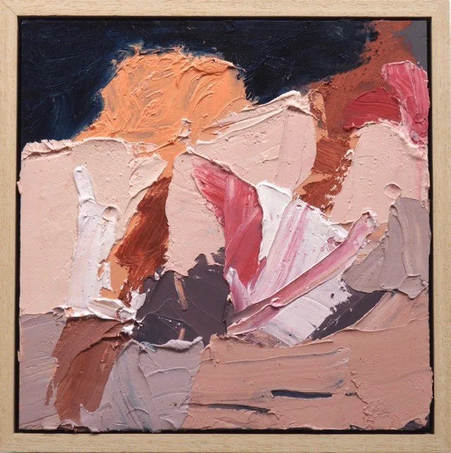 Framed abstract artwork with layered pink, rust and peach brushstrokes.