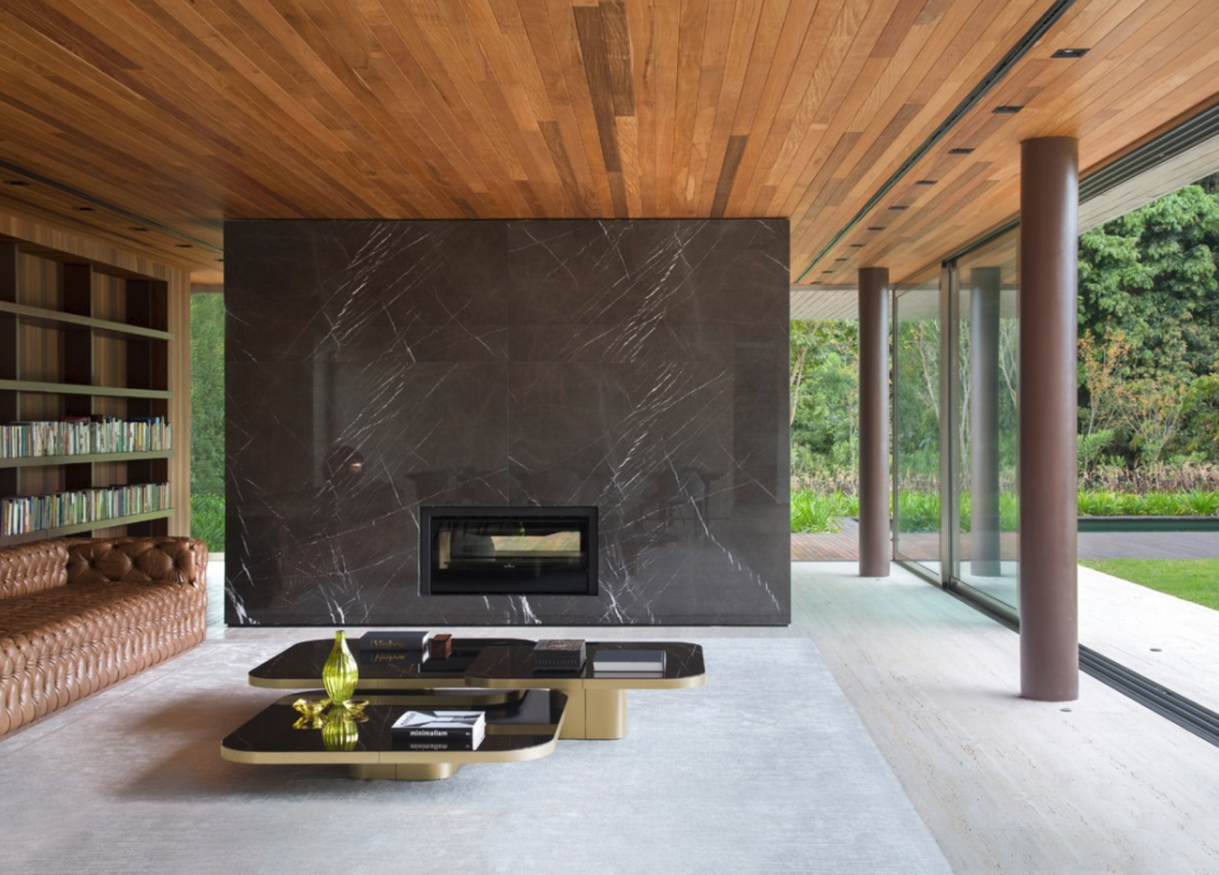 Living room with a timber ceiling, dark fireplace and garden-facing glazing.