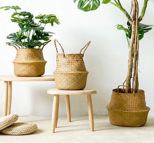Woven baskets used for plants and storage beside a timber stool.