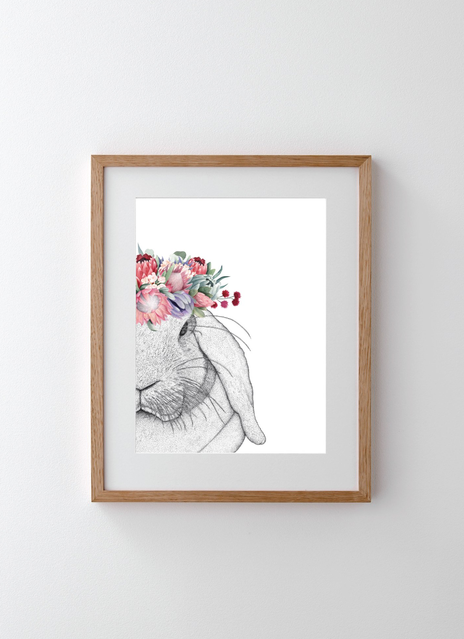 Framed floral portrait artwork on a pale wall.