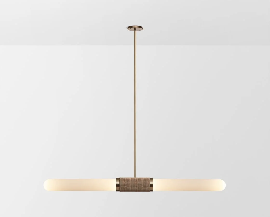 Slim brass-toned pendant light with a horizontal glowing shade.