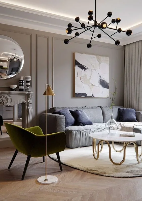 Living room with a branching chandelier above seating and a round table.