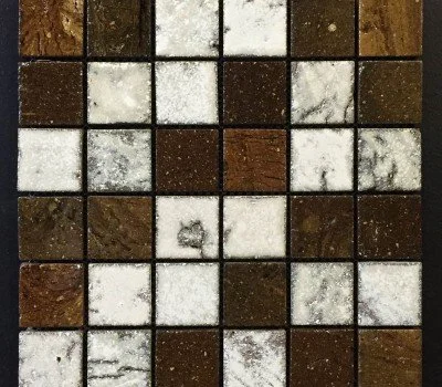 Grid of small square tiles in brown, cream and dark tones.