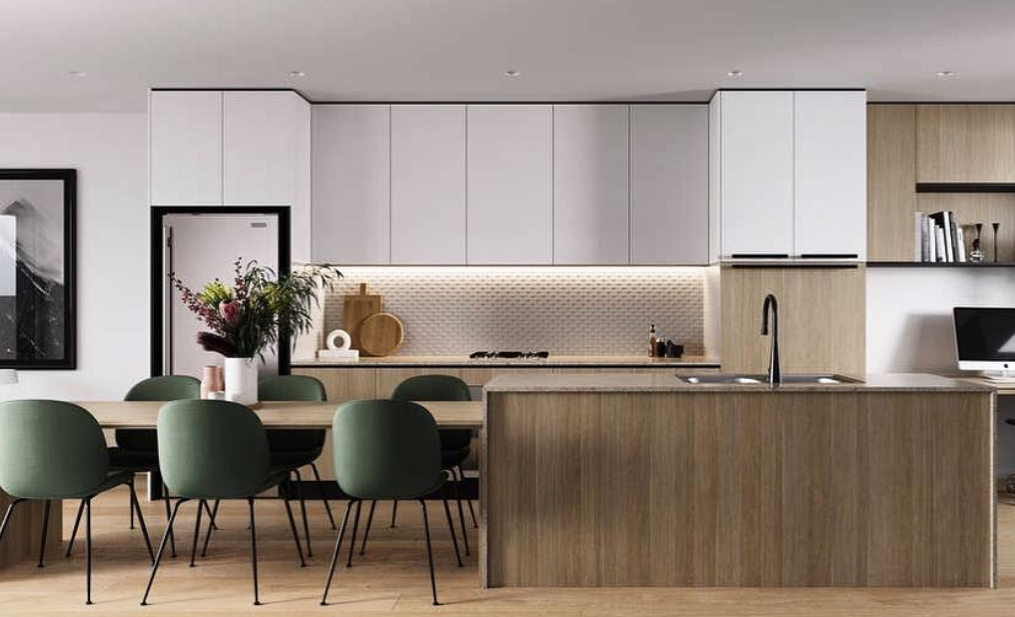 Kitchen with pale upper cabinetry, a timber-front island and green dining chairs.