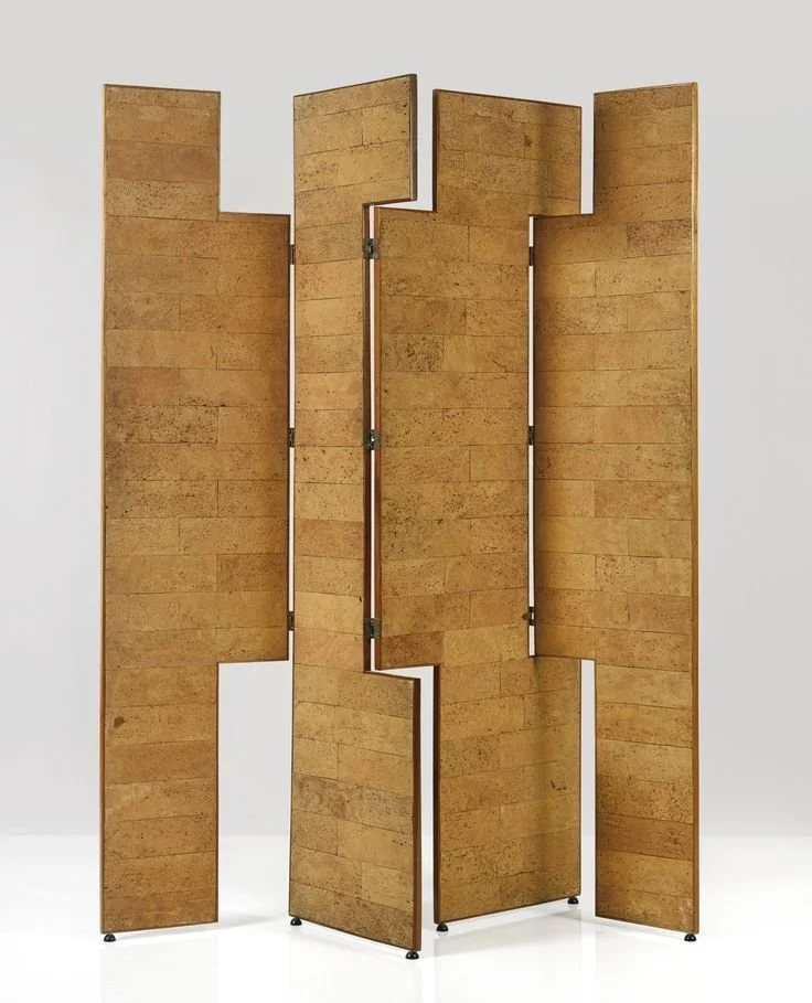 Sculptural gold-toned folding screen with stepped rectangular panels.
