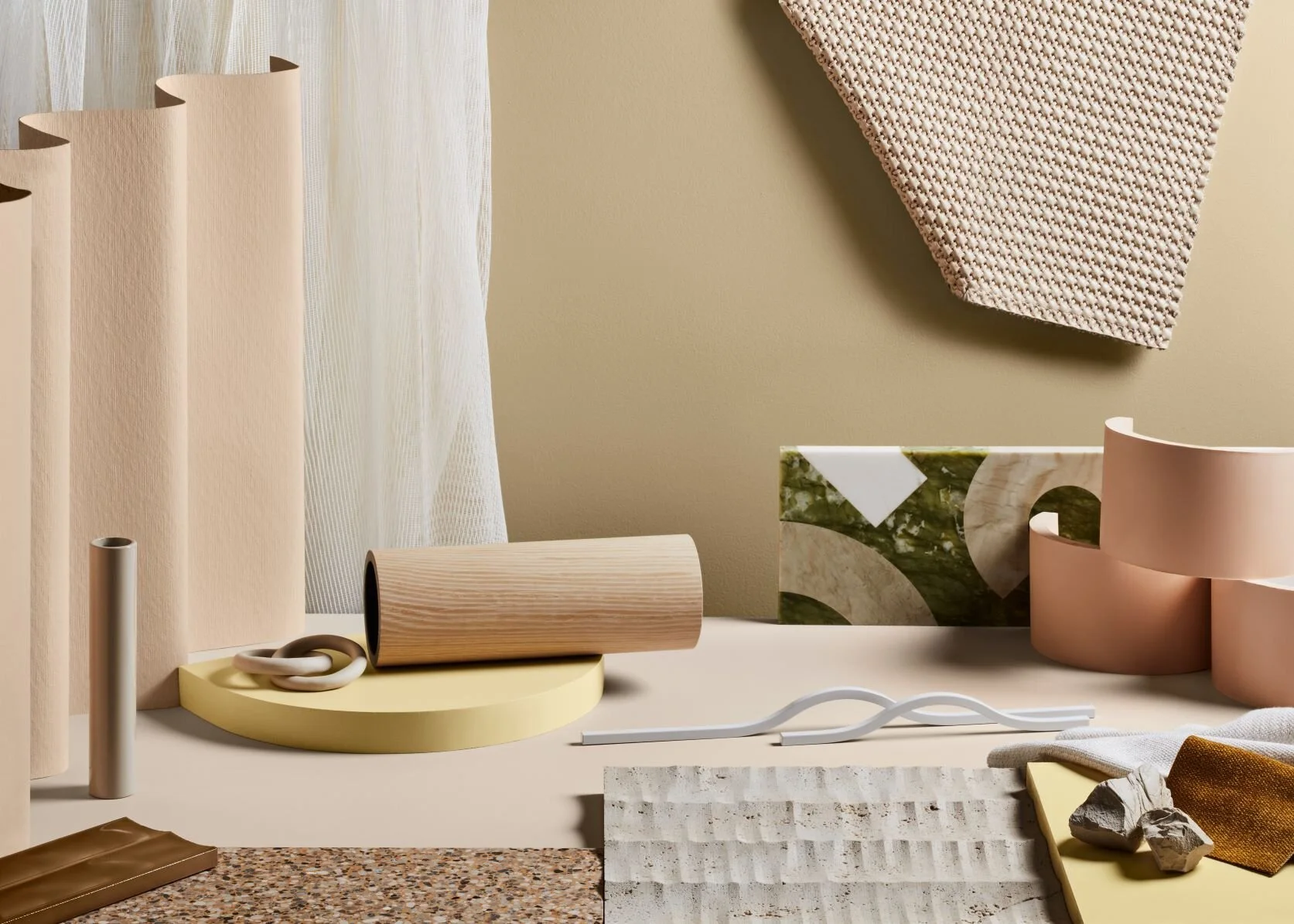 Warm neutral palette of blush forms, cream surfaces and woven samples.