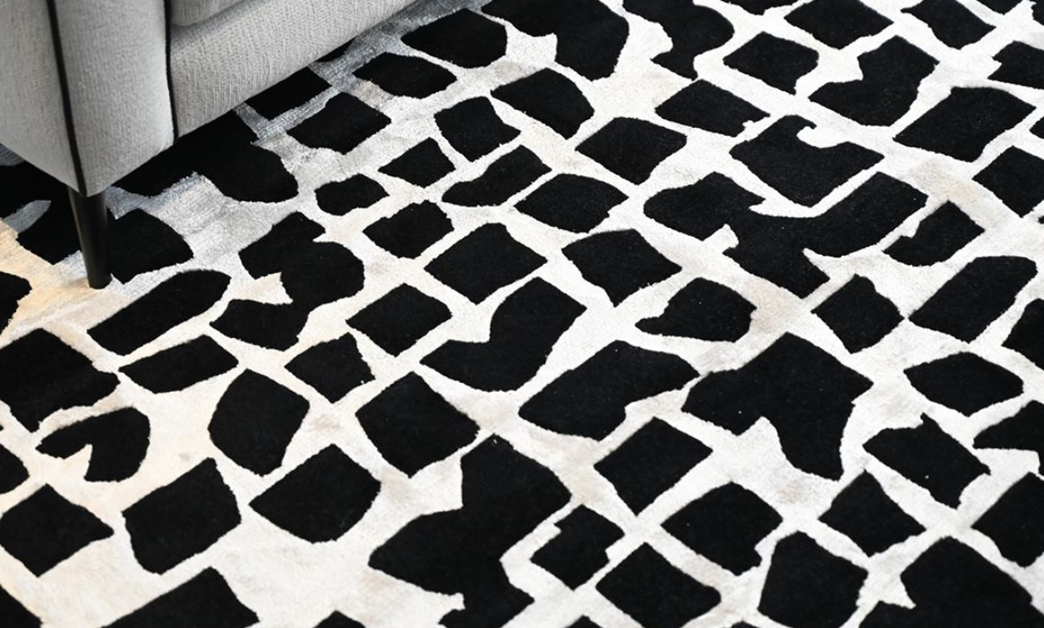 Black-and-white rug with an irregular geometric pattern.
