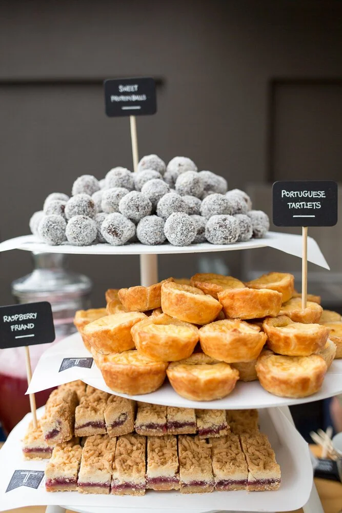 Tiered serving stands displaying pastries and sweet treats.