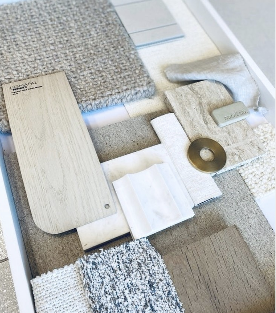 Material palette of timber, fabric, stone samples and metal finishes.