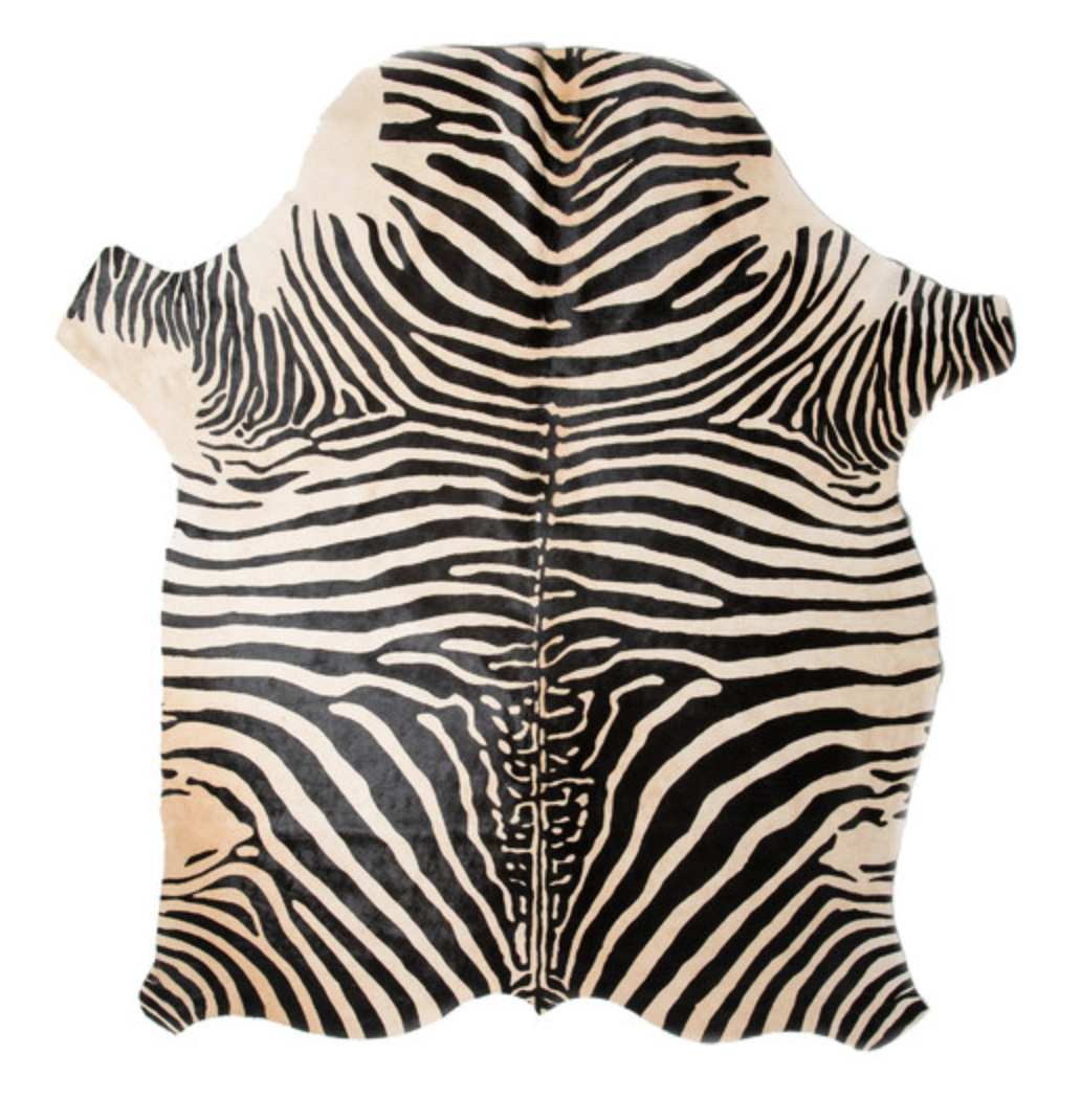 Black-and-white zebra-patterned hide rug shown against white.