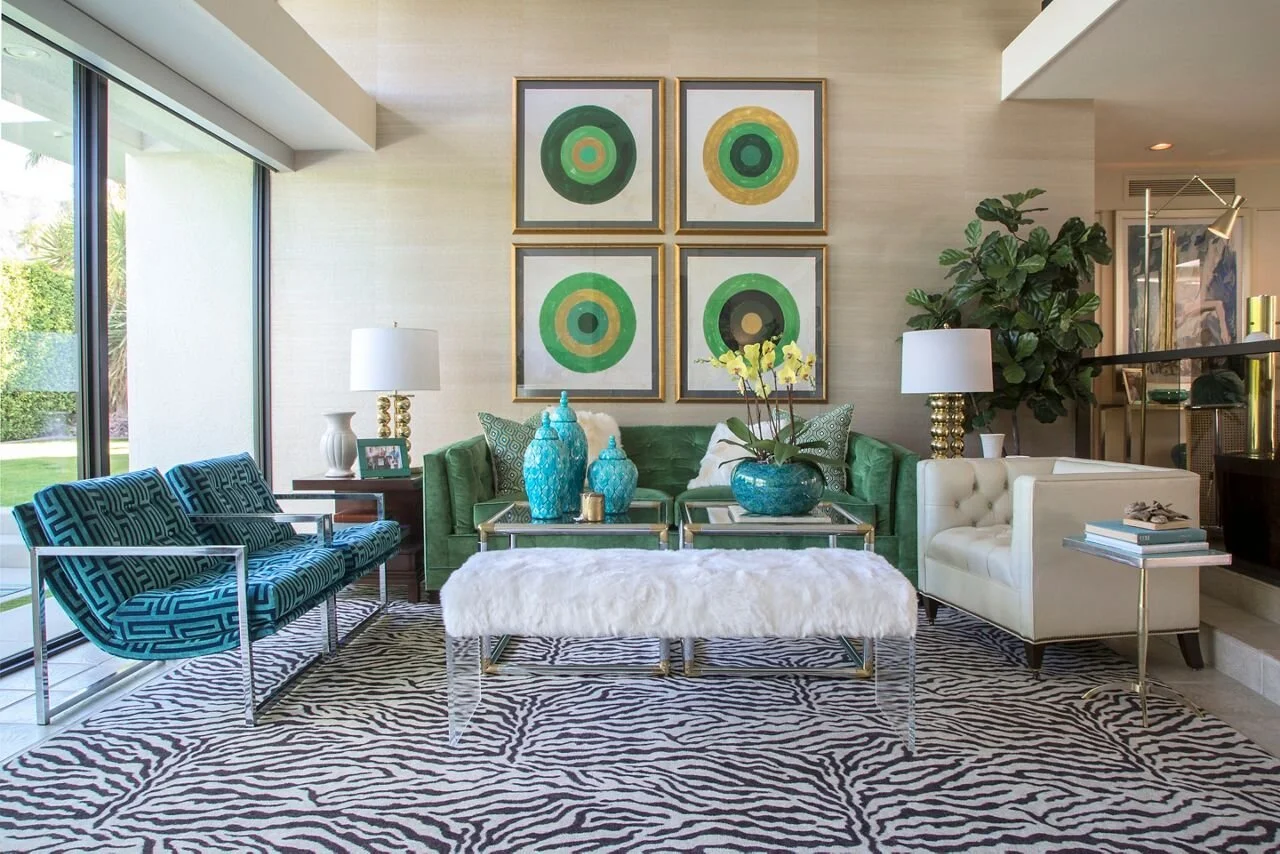 Green and turquoise living-room furnishings beneath framed geometric artworks.