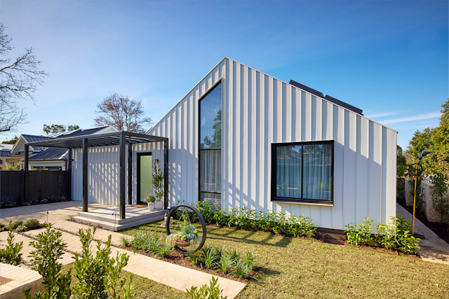 Contemporary renovated house with vertical cladding and landscaped garden.