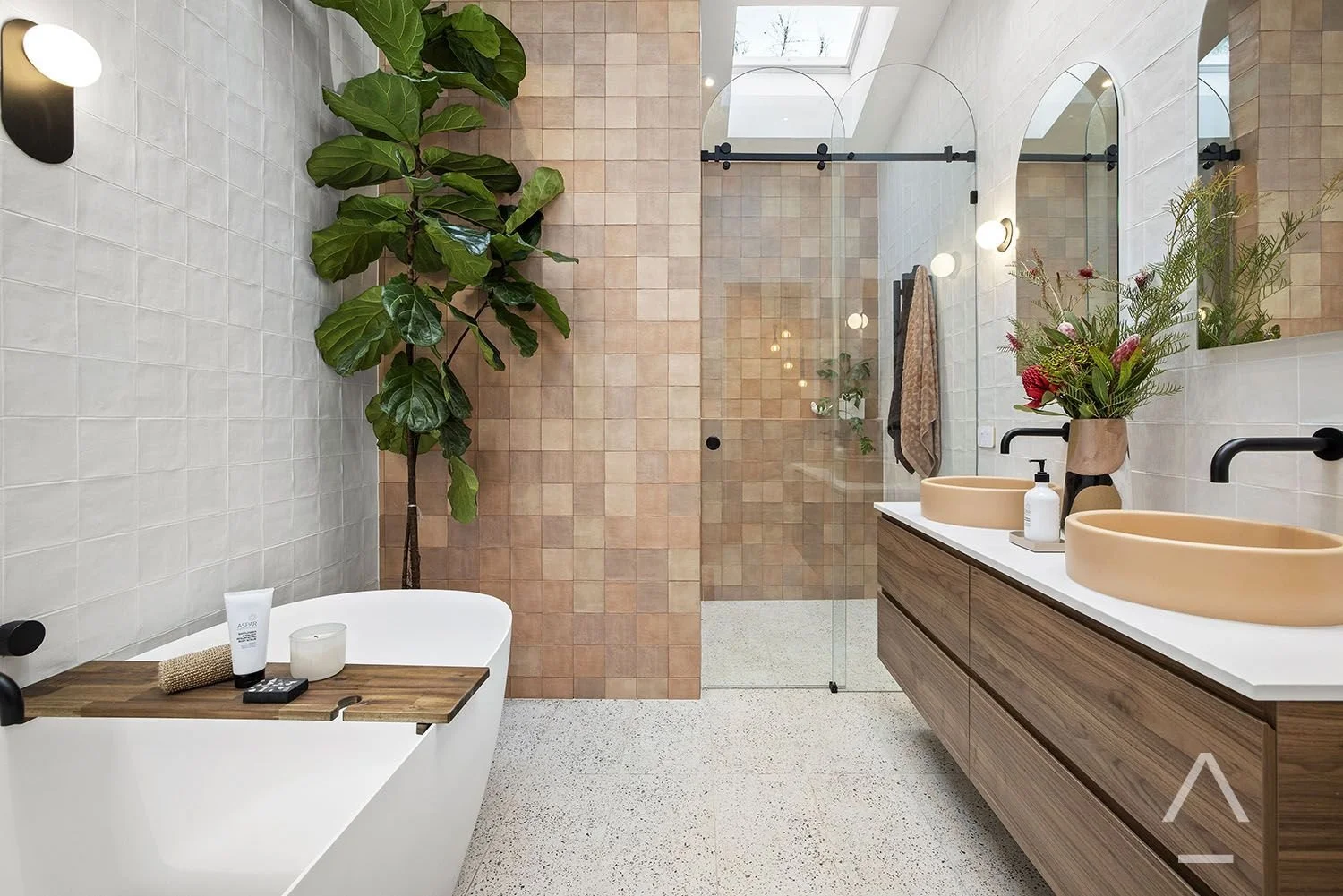 Bathroom with terracotta basin, timber vanity, bath and leafy indoor plant.